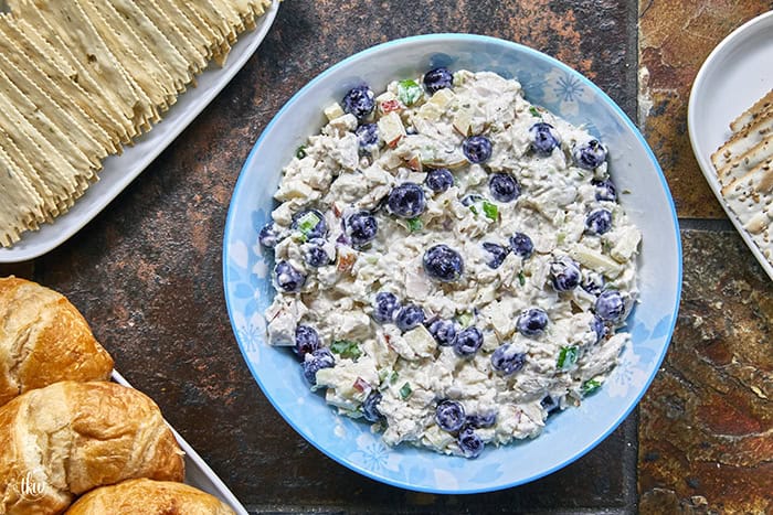 A creamy deli chicken salad packed with tender white meat chicken, sweet fresh blueberries, and crunchy diced apples, accented by shallots, scallions, and celery, all tossed in a seasoned tarragon-mayo dressing brightened with apple cider vinegar.