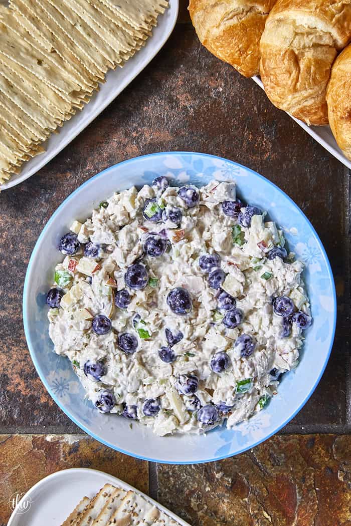 A creamy deli chicken salad packed with tender white meat chicken, sweet fresh blueberries, and crunchy diced apples, accented by shallots, scallions, and celery, all tossed in a seasoned tarragon-mayo dressing brightened with apple cider vinegar.