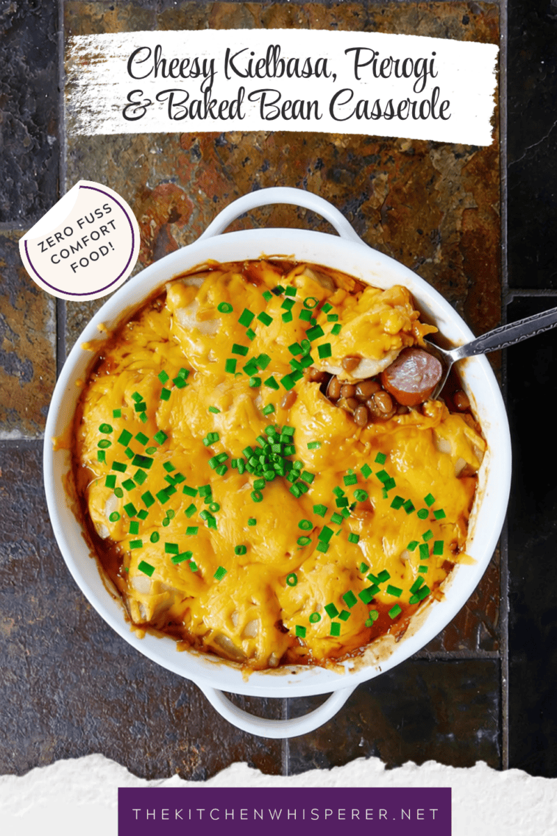 A hearty comfort food casserole made with smoky sliced kielbasa sausage and sweet baked beans, topped with pillowy potato-and-cheese pierogies, melted sharp cheddar cheese, and a sprinkle of fresh green onions.