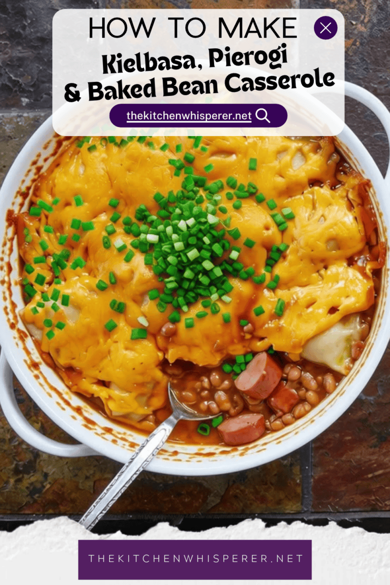A hearty comfort food casserole made with smoky sliced kielbasa sausage and sweet baked beans, topped with pillowy potato-and-cheese pierogies, melted sharp cheddar cheese, and a sprinkle of fresh green onions.