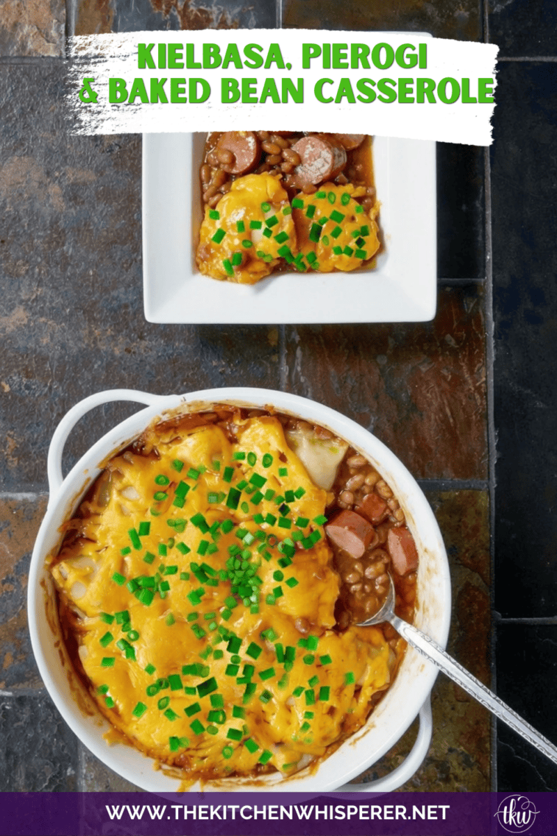 A hearty comfort food casserole made with smoky sliced kielbasa sausage and sweet baked beans, topped with pillowy potato-and-cheese pierogies, melted sharp cheddar cheese, and a sprinkle of fresh green onions.