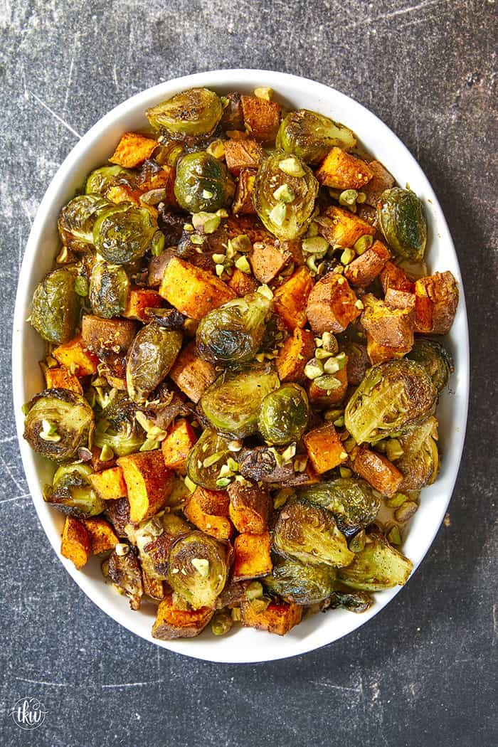 Sheet-pan roasted Brussels sprouts and sweet potatoes tossed in a warm spiced maple glaze and toasted pistachios. An easy side dish that is naturally vegan, gluten-free, and perfect for any dinner table.