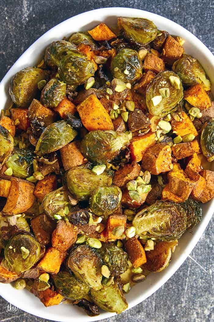 Sheet-pan roasted Brussels sprouts and sweet potatoes tossed in a warm spiced maple glaze and toasted pistachios. An easy side dish that is naturally vegan, gluten-free, and perfect for any dinner table.