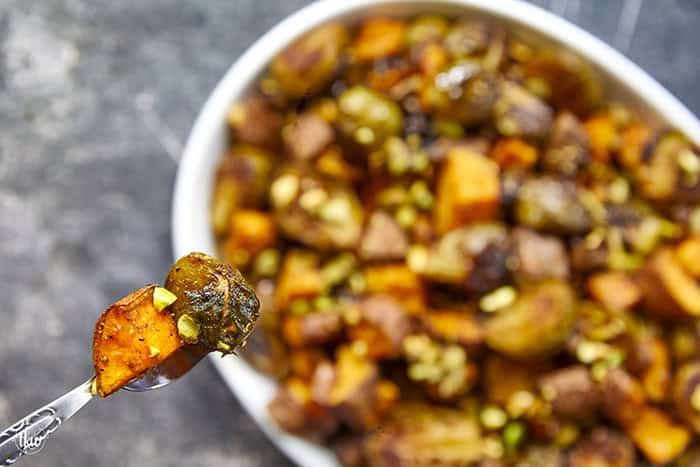 Sheet-pan roasted Brussels sprouts and sweet potatoes tossed in a warm spiced maple glaze and toasted pistachios. An easy side dish that is naturally vegan, gluten-free, and perfect for any dinner table.