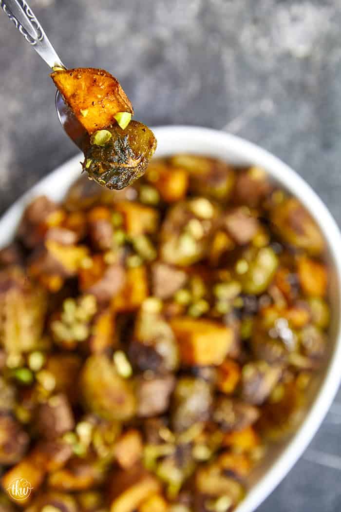 Sheet-pan roasted Brussels sprouts and sweet potatoes tossed in a warm spiced maple glaze and toasted pistachios. An easy side dish that is naturally vegan, gluten-free, and perfect for any dinner table.