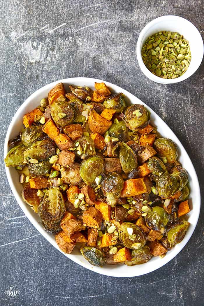 Sheet-pan roasted Brussels sprouts and sweet potatoes tossed in a warm spiced maple glaze and toasted pistachios. An easy side dish that is naturally vegan, gluten-free, and perfect for any dinner table.