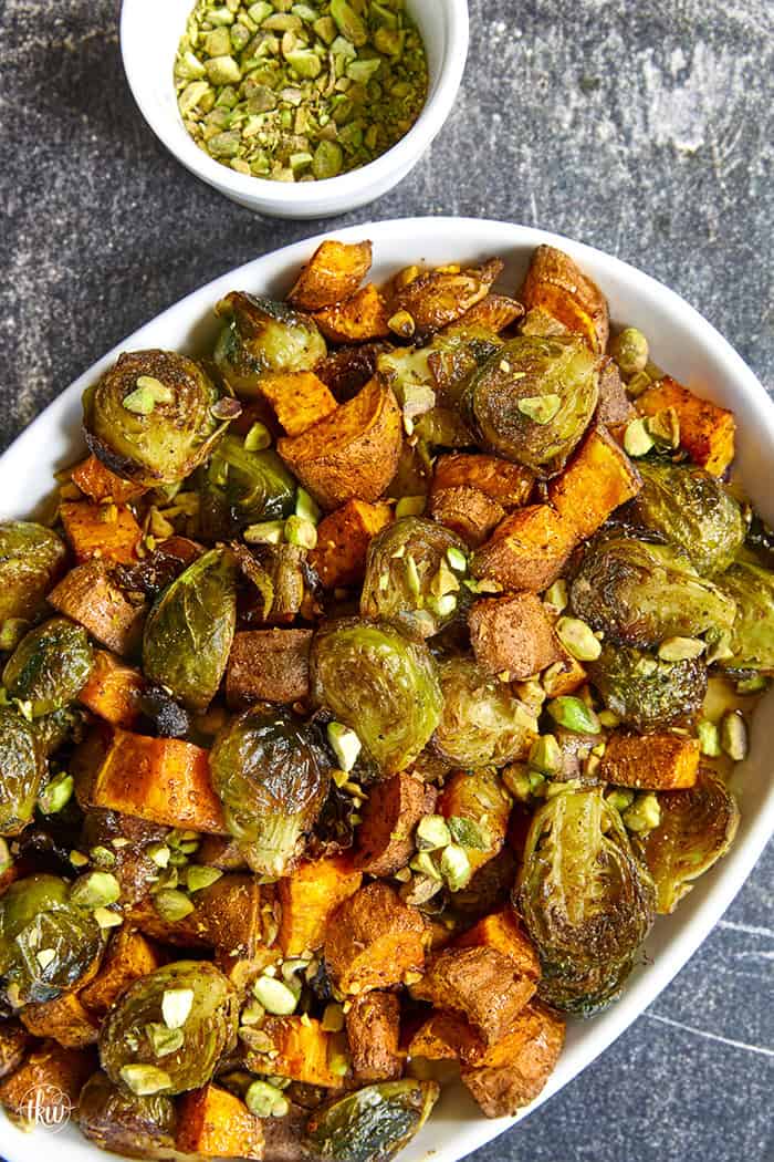 Sheet-pan roasted Brussels sprouts and sweet potatoes tossed in a warm spiced maple glaze and toasted pistachios. An easy side dish that is naturally vegan, gluten-free, and perfect for any dinner table.