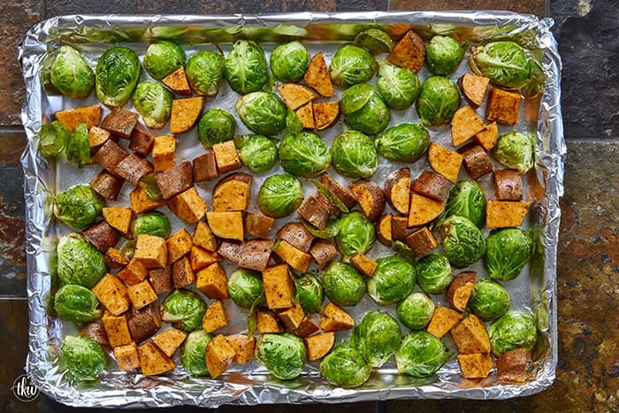 Sheet-pan roasted Brussels sprouts and sweet potatoes tossed in a warm spiced maple glaze and toasted pistachios. An easy side dish that is naturally vegan, gluten-free, and perfect for any dinner table.